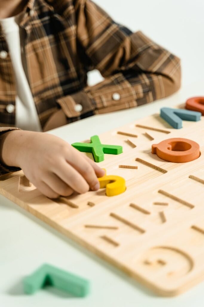 Person Playing Yellow and Green Lego Blocks